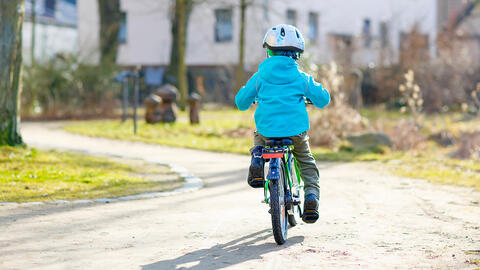 Barn cykler på cykelsti
