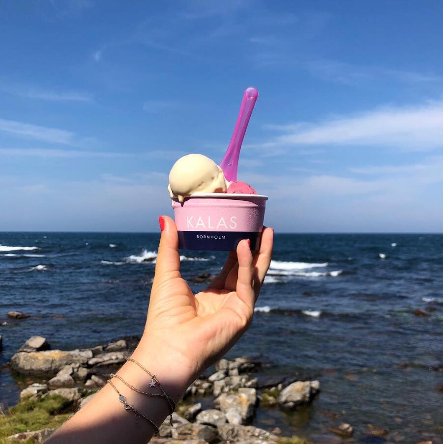 Isbæger med is i hånd foran havet